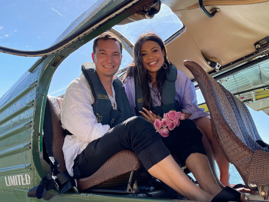 A young couple in the back seat of seaplane